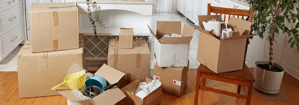 Packed moving boxes and household items in a kitchen before move-out or move-in cleaning, Wichita, KS.